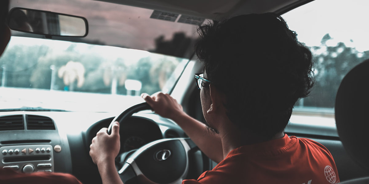 Insured young boy driving a car